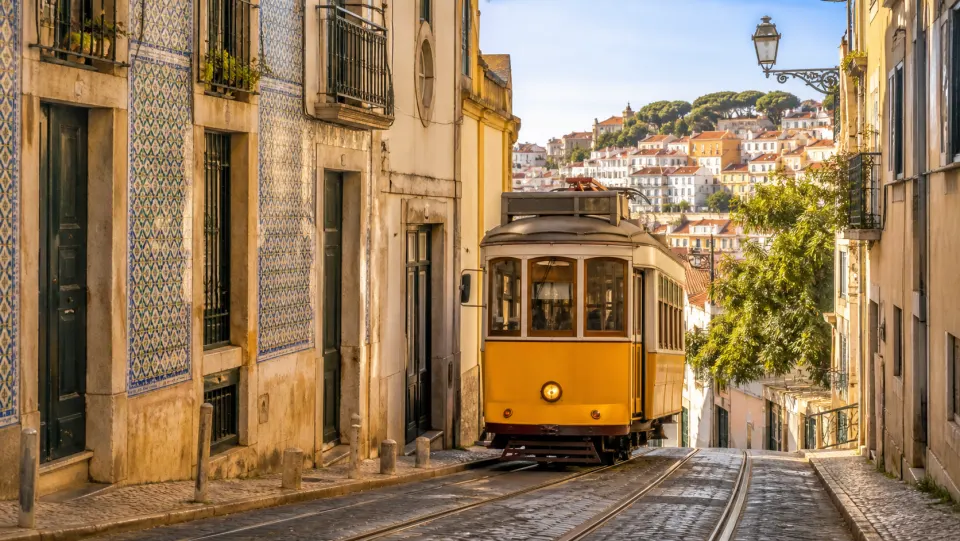 Yellow tram on a traditional Lisbon street, Portugal